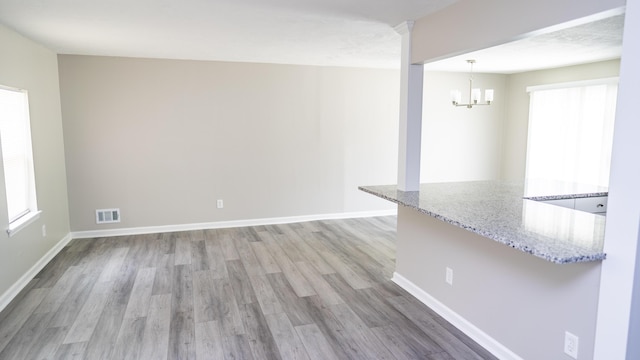2154 Peppermint Pl, Augusta, GA 30906 - interior space featuring baseboards, light wood-style floors, an inviting chandelier, and visible vents