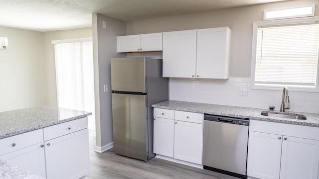 2154 Peppermint Pl, Augusta, GA 30906 - kitchen with white cabinetry, light wood-style floors, appliances with stainless steel finishes, and a sink