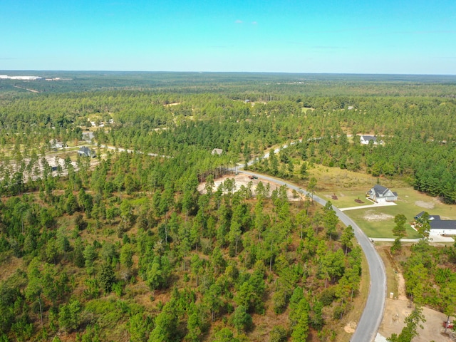 aerial view featuring a wooded view