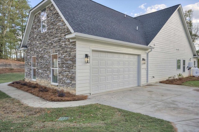 view of side of home featuring a garage