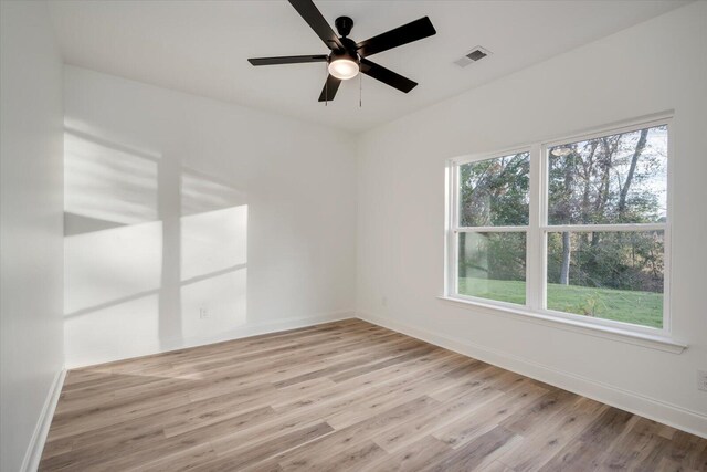 unfurnished room with ceiling fan and light wood-type flooring