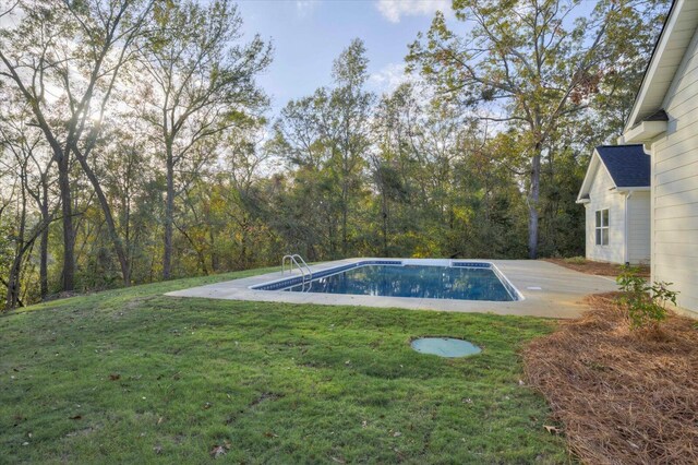 view of swimming pool featuring a yard and a patio area