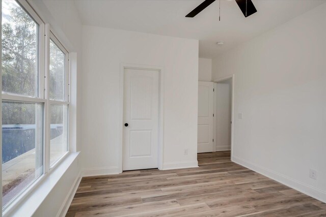 empty room featuring light hardwood / wood-style flooring and ceiling fan