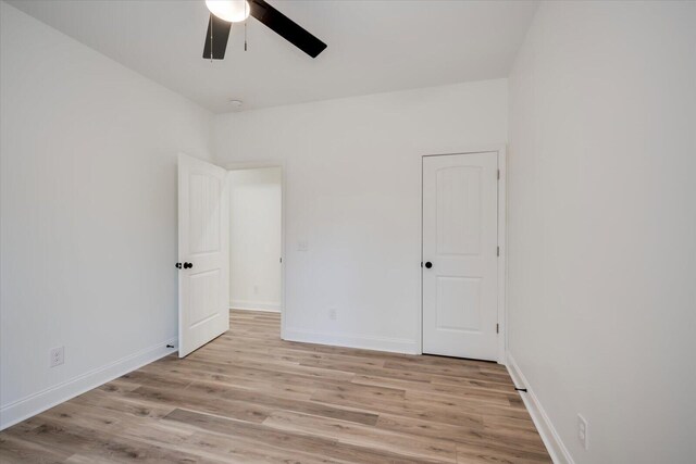 unfurnished room with ceiling fan and light wood-type flooring