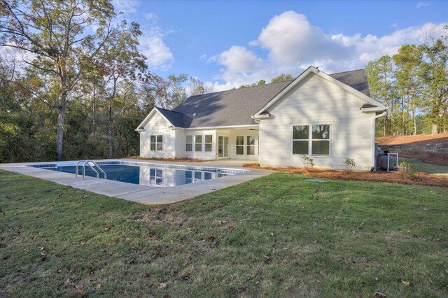 back of property featuring a lawn and a patio