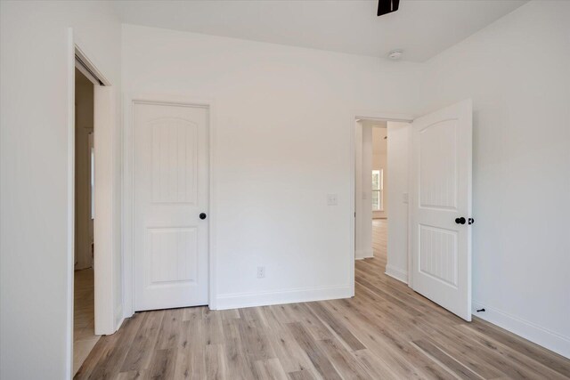 unfurnished bedroom with light wood-type flooring and a closet