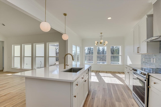 kitchen featuring backsplash, sink, an island with sink, appliances with stainless steel finishes, and a notable chandelier