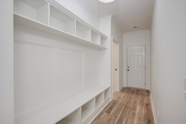 mudroom featuring light hardwood / wood-style floors and ornamental molding