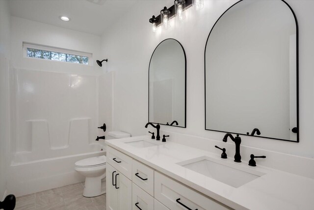 full bathroom with tile patterned floors, vanity, shower / bath combination, and toilet