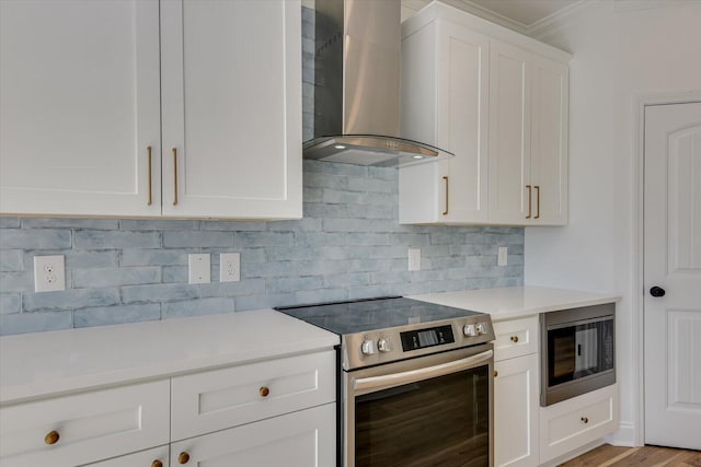 kitchen with stainless steel electric range, light hardwood / wood-style flooring, wall chimney exhaust hood, built in microwave, and white cabinetry