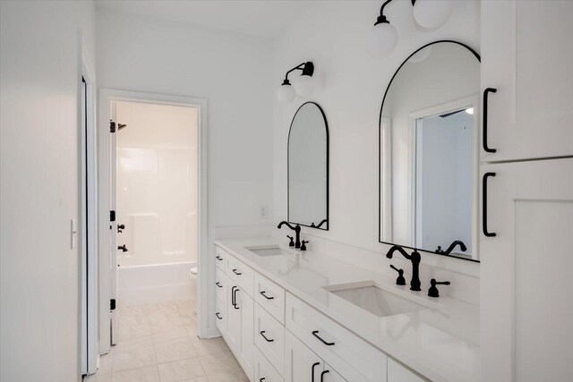 full bathroom with tile patterned flooring, vanity, shower / bath combination, and toilet