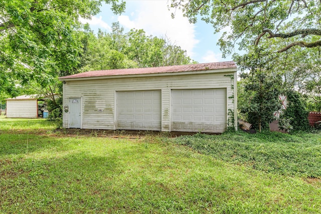 garage featuring a yard