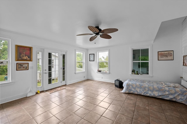 unfurnished bedroom with access to exterior, ceiling fan, and light tile patterned flooring