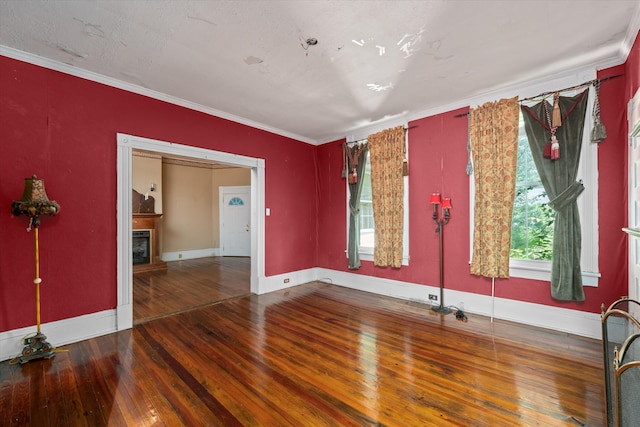 unfurnished room featuring hardwood / wood-style floors and ornamental molding