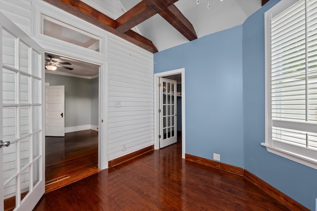 spare room with vaulted ceiling with beams, ceiling fan, french doors, and dark hardwood / wood-style floors