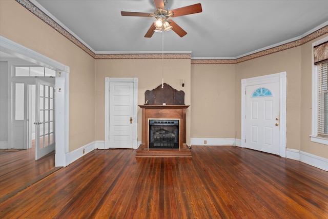 unfurnished living room featuring dark hardwood / wood-style flooring, ceiling fan, and crown molding