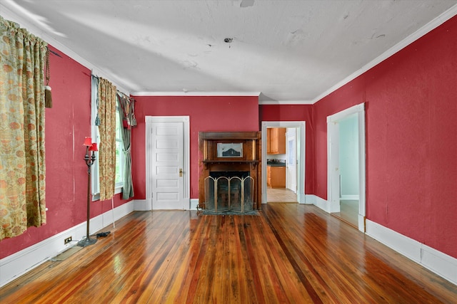 unfurnished living room with crown molding and hardwood / wood-style flooring