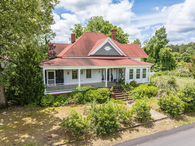 farmhouse inspired home featuring covered porch