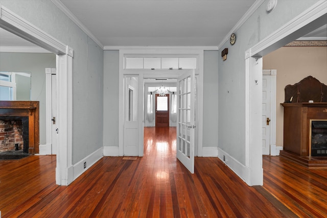 hallway featuring dark hardwood / wood-style floors, ornamental molding, and french doors