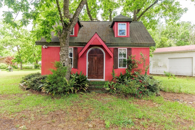 view of front of home featuring an outbuilding and a front yard