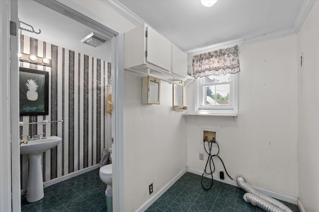 bathroom featuring tile patterned floors, toilet, ornamental molding, and sink