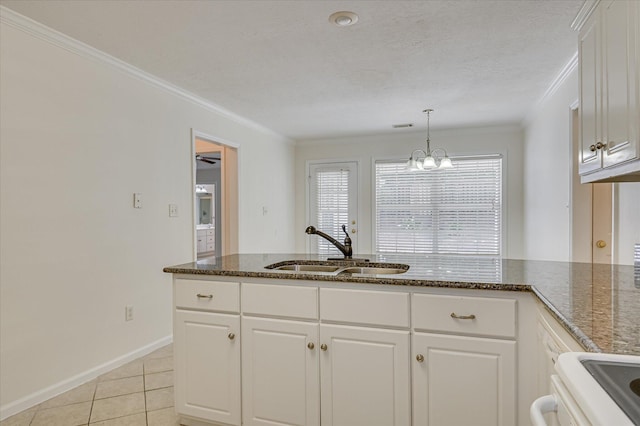 392 Sandleton Way, Evans, GA 30809 - kitchen featuring crown molding, white cabinets, dark stone counters, light tile patterned floors, and pendant lighting
