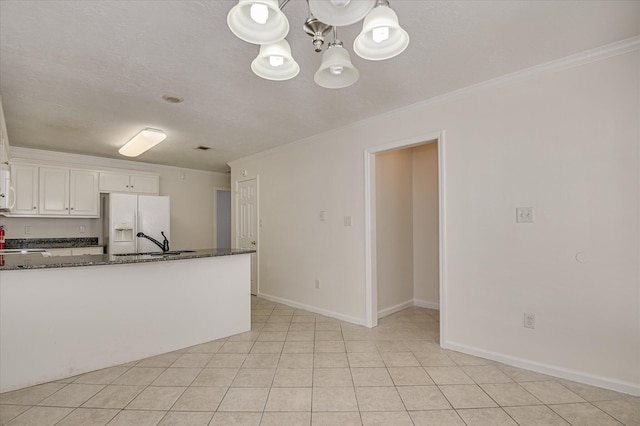 392 Sandleton Way, Evans, GA 30809 - kitchen with white fridge with ice dispenser, ornamental molding, a chandelier, white cabinetry, and dark stone countertops