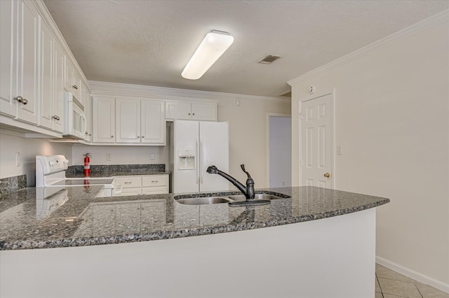 392 Sandleton Way, Evans, GA 30809 - kitchen featuring white appliances, dark stone counters, white cabinets, a peninsula, and ornamental molding