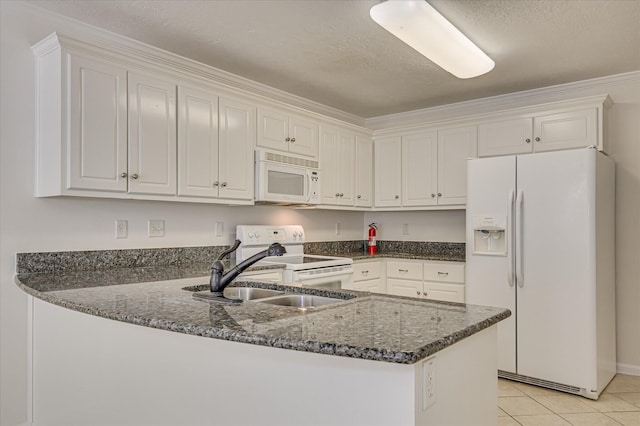 392 Sandleton Way, Evans, GA 30809 - kitchen featuring white appliances, a peninsula, white cabinets, dark stone countertops, and light tile patterned floors