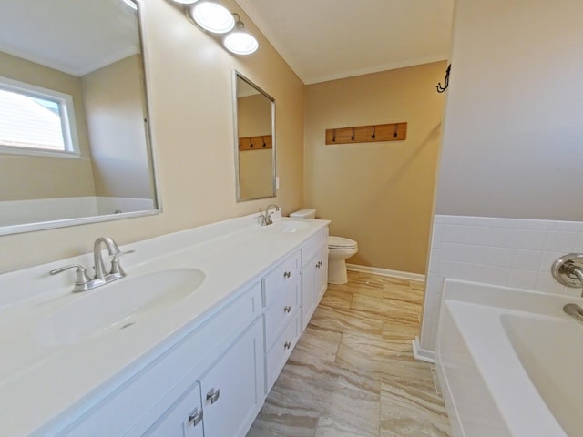 bathroom with vanity, toilet, and a washtub