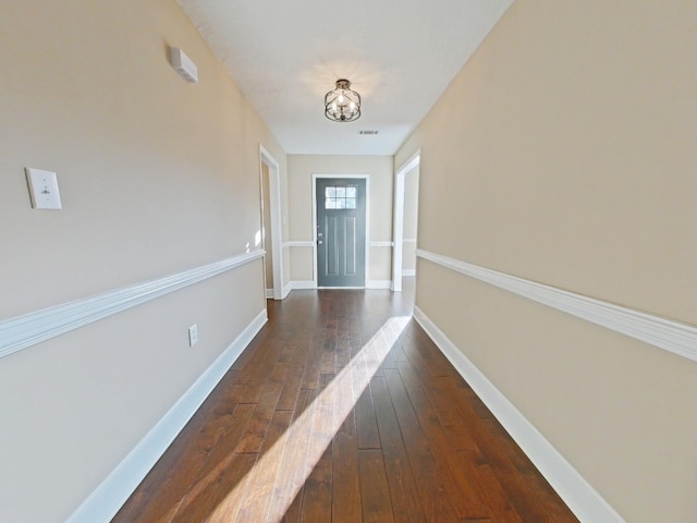 doorway with dark wood-type flooring