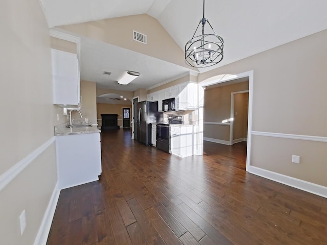 interior space featuring lofted ceiling, sink, a chandelier, and dark hardwood / wood-style floors