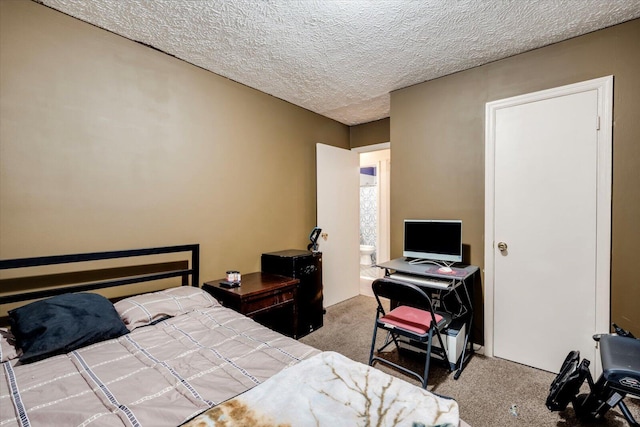 bedroom featuring a textured ceiling and carpet