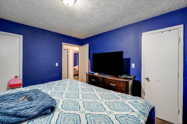 carpeted bedroom with a textured ceiling