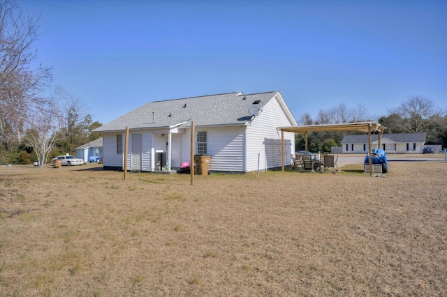 rear view of house with a lawn