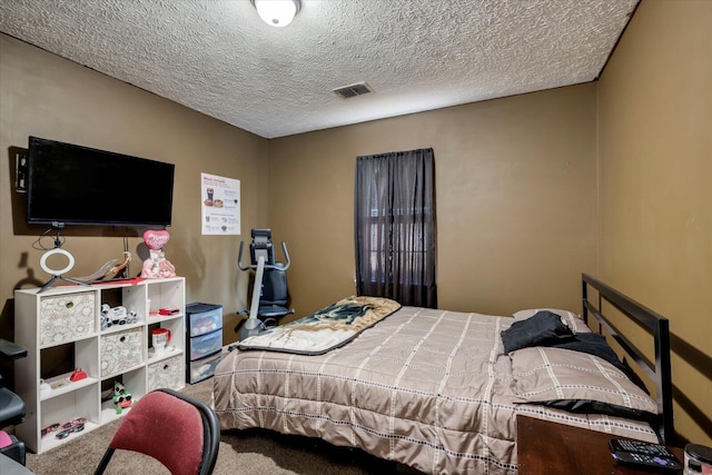 bedroom featuring a textured ceiling and carpet flooring