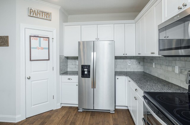 kitchen featuring backsplash, stainless steel appliances, and white cabinetry