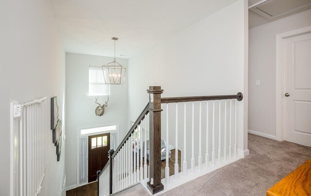 interior space featuring carpet floors and an inviting chandelier