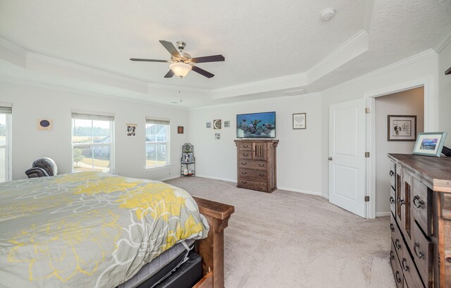 bedroom with a raised ceiling, ceiling fan, light colored carpet, and ornamental molding