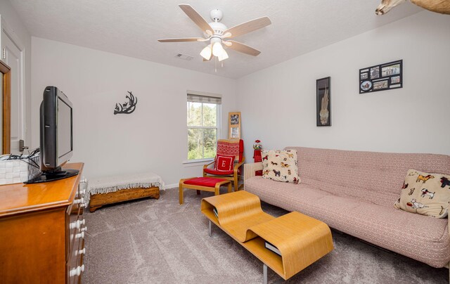 living room featuring carpet flooring and ceiling fan