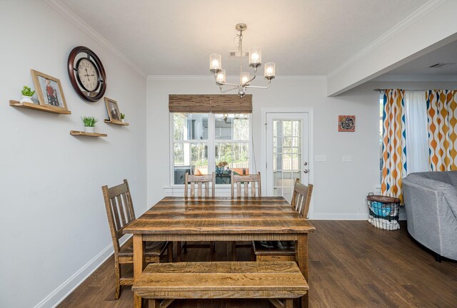 dining room featuring dark hardwood / wood-style flooring, a chandelier, and ornamental molding