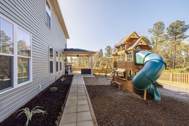 view of playground featuring central air condition unit, a patio area, and ceiling fan