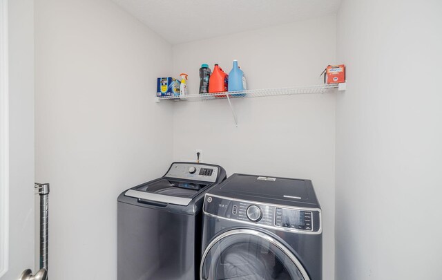 washroom with washing machine and clothes dryer