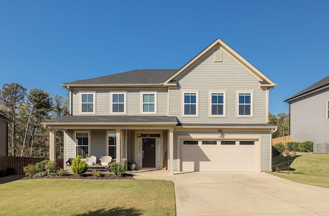 view of front of house featuring a front yard, a porch, and a garage