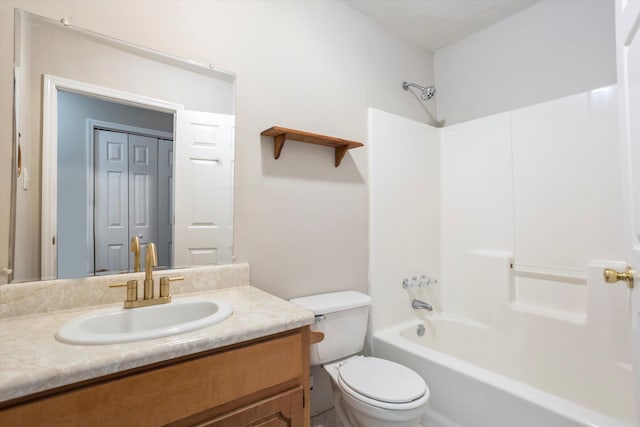 bathroom featuring bathing tub / shower combination, vanity, and toilet