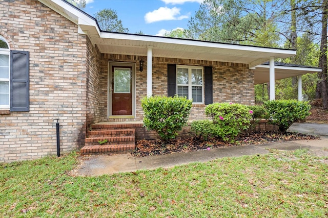 doorway to property featuring brick siding