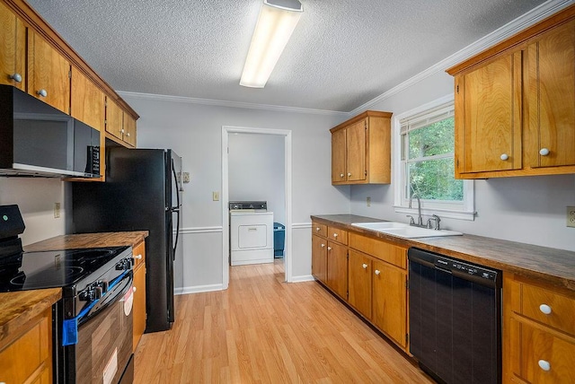 134 Robin Rd, Barnwell, SC 29812 - kitchen featuring black appliances, washer / clothes dryer, a textured ceiling, light wood-type flooring, and brown cabinetry
