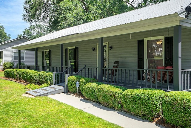 134 Robin Rd, Barnwell, SC 29812 - view of front of home with covered porch, a front lawn, and a metal roof