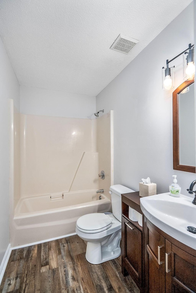 134 Robin Rd, Barnwell, SC 29812 - full bath with wood finished floors, vanity, shower / washtub combination, and a textured ceiling