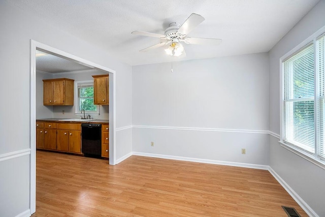 134 Robin Rd, Barnwell, SC 29812 - kitchen featuring dishwasher, light wood-style floors, brown cabinets, and a ceiling fan